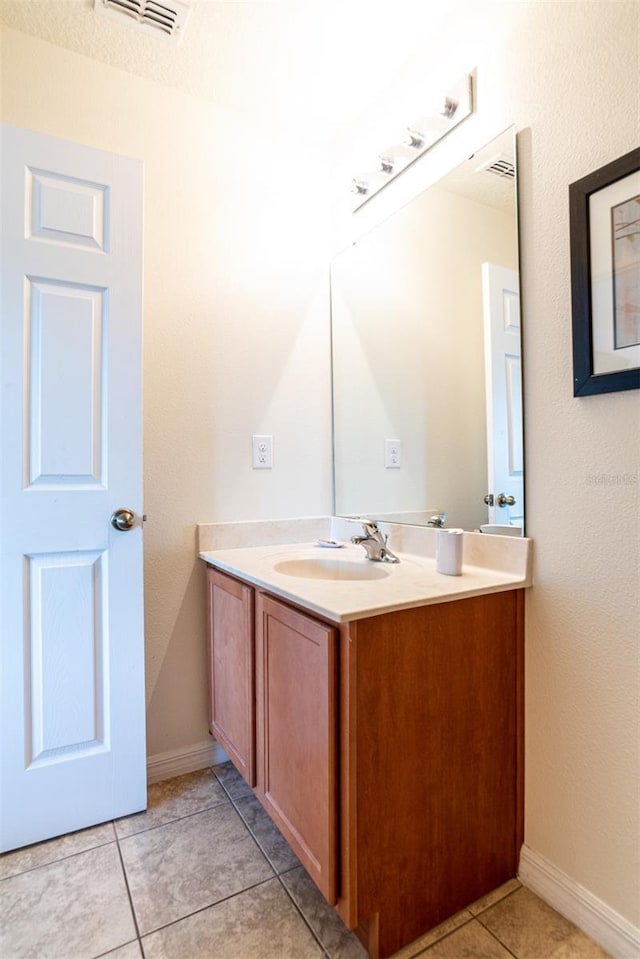 bathroom with tile patterned flooring and vanity