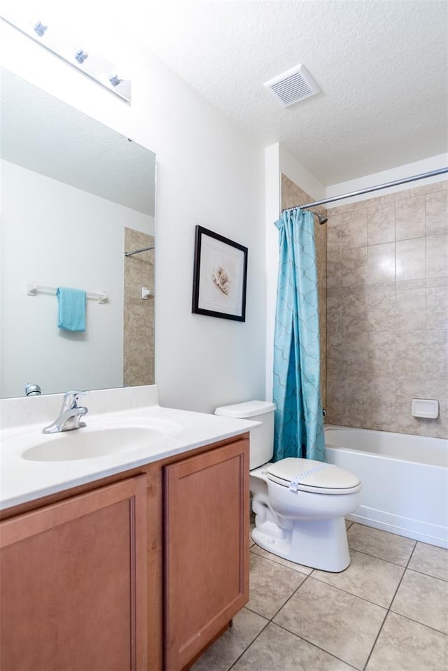 full bathroom featuring shower / tub combo, vanity, a textured ceiling, tile patterned floors, and toilet