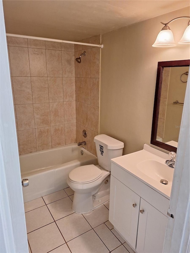 full bathroom with tile patterned flooring, vanity, tiled shower / bath combo, and toilet