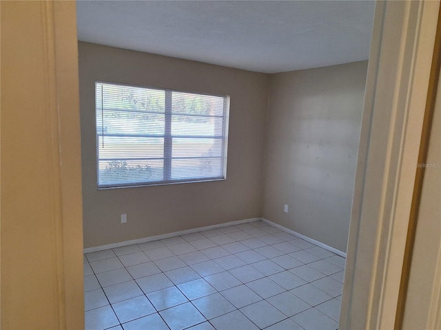 spare room featuring light tile patterned floors