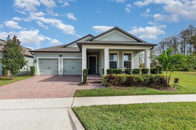 view of front of home featuring a garage and a front yard