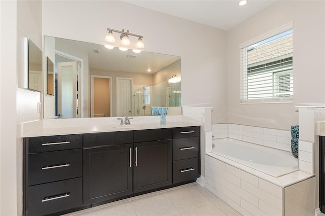 bathroom featuring vanity, independent shower and bath, and tile patterned flooring