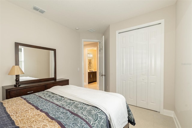 bedroom with light tile patterned floors and a closet