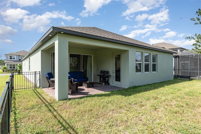 back of house with an outdoor living space, a lawn, and a patio