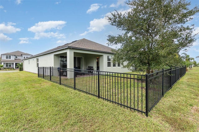 back of property featuring a yard