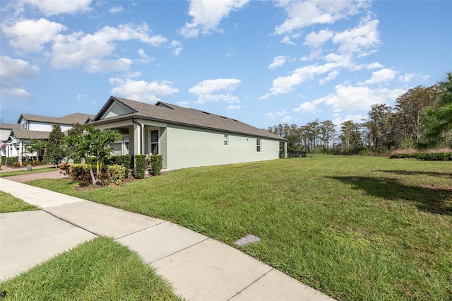 view of side of home featuring a lawn