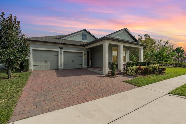 view of front facade with a garage and a yard