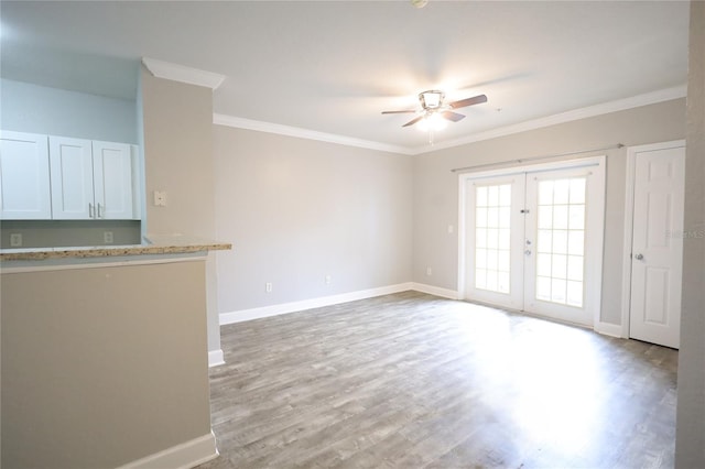 interior space featuring crown molding, ceiling fan, light hardwood / wood-style floors, and french doors