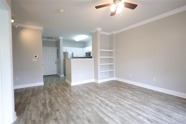 unfurnished living room with ceiling fan, ornamental molding, and light wood-type flooring