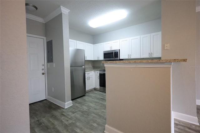 kitchen with white cabinetry, stainless steel appliances, and kitchen peninsula