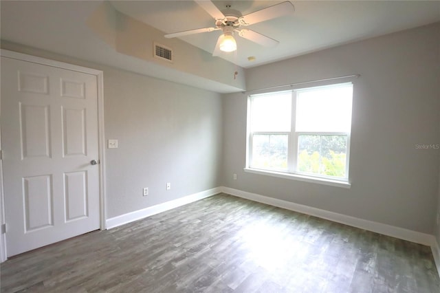 empty room with hardwood / wood-style flooring and ceiling fan