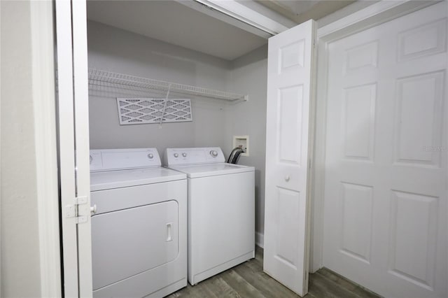 washroom featuring washing machine and dryer and dark hardwood / wood-style floors