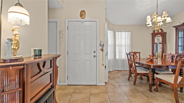 foyer entrance with light tile patterned flooring and a chandelier