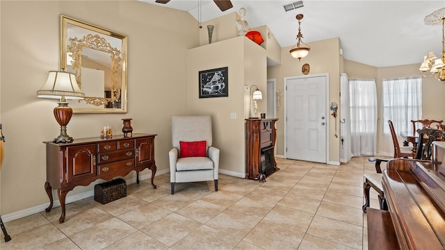 entryway with lofted ceiling, ceiling fan with notable chandelier, and light tile patterned flooring