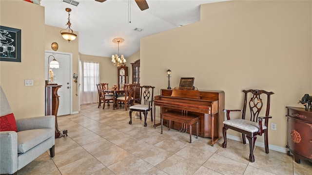 sitting room with ceiling fan, lofted ceiling, and light tile patterned floors