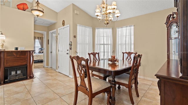 dining space with vaulted ceiling, a chandelier, a textured ceiling, and light tile patterned flooring