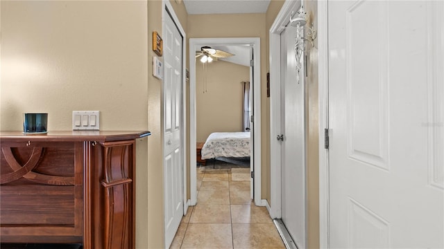 hall featuring light tile patterned flooring