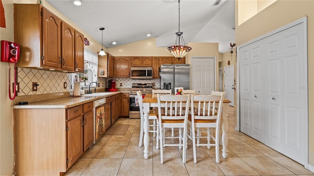 kitchen with sink, decorative light fixtures, a center island, and appliances with stainless steel finishes