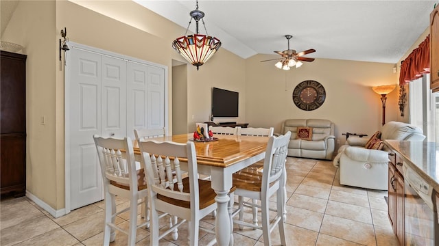 dining room featuring light tile patterned flooring, lofted ceiling, and ceiling fan