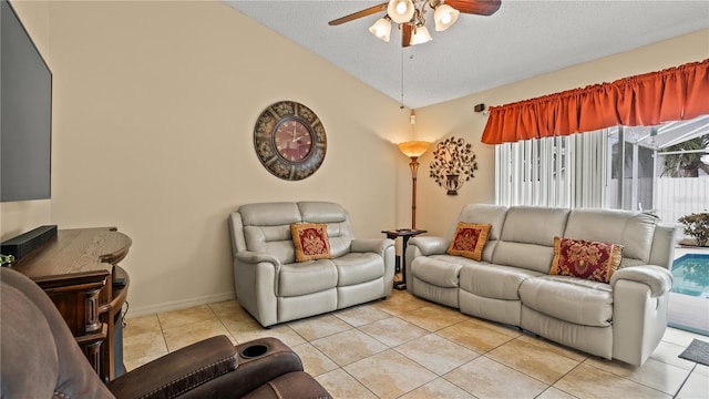 living room featuring lofted ceiling, a textured ceiling, ceiling fan, and light tile patterned flooring