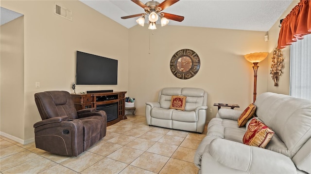 tiled living room featuring ceiling fan, lofted ceiling, and a textured ceiling