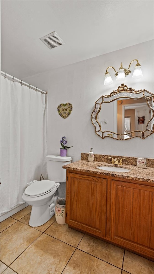 bathroom with vanity, tile patterned floors, and toilet