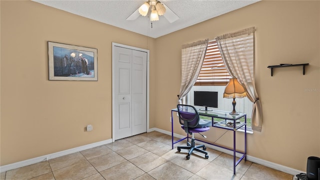 tiled home office featuring ceiling fan, a healthy amount of sunlight, and a textured ceiling