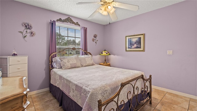 tiled bedroom with ceiling fan and a textured ceiling