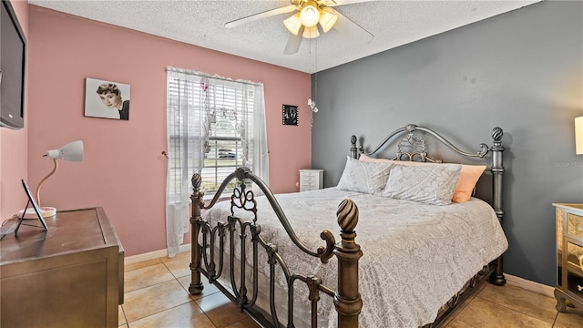 bedroom with ceiling fan, a textured ceiling, and light tile patterned floors