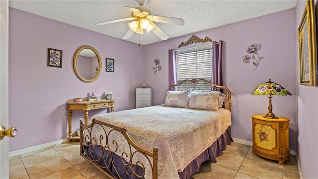 tiled bedroom featuring ceiling fan and a textured ceiling