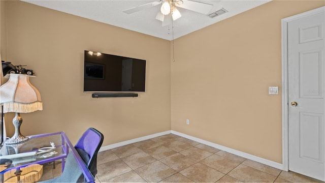 office area with light tile patterned floors and ceiling fan