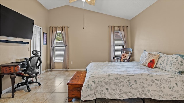 bedroom featuring lofted ceiling, ceiling fan, and light tile patterned flooring