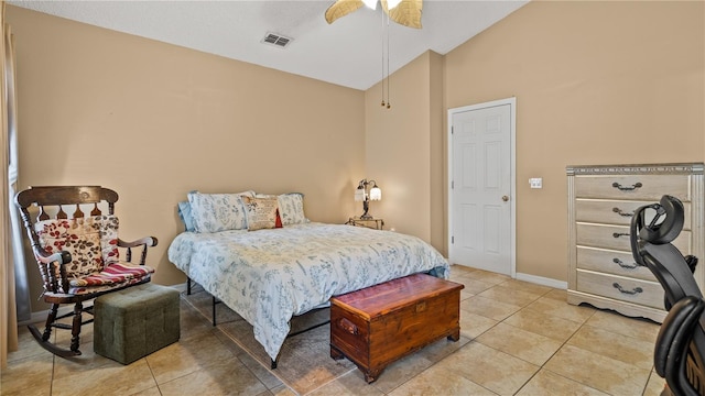 tiled bedroom with ceiling fan and vaulted ceiling