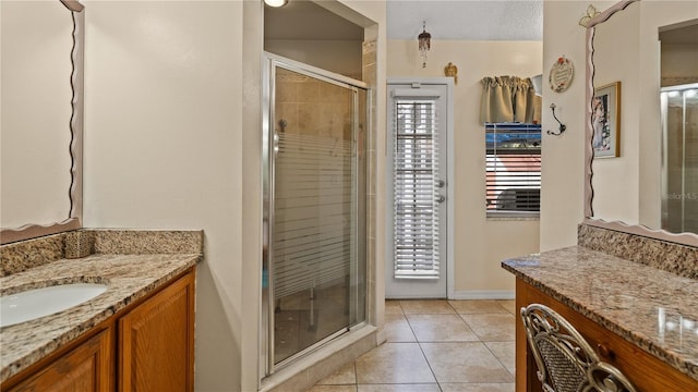 bathroom featuring vanity, an enclosed shower, and tile patterned floors