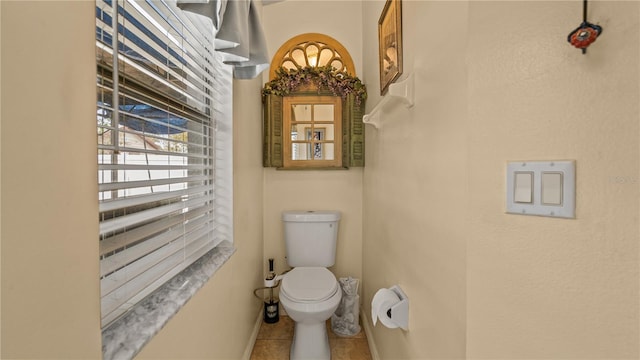 bathroom with tile patterned floors and toilet