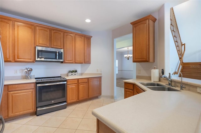 kitchen featuring decorative light fixtures, sink, a chandelier, light tile patterned floors, and stainless steel appliances