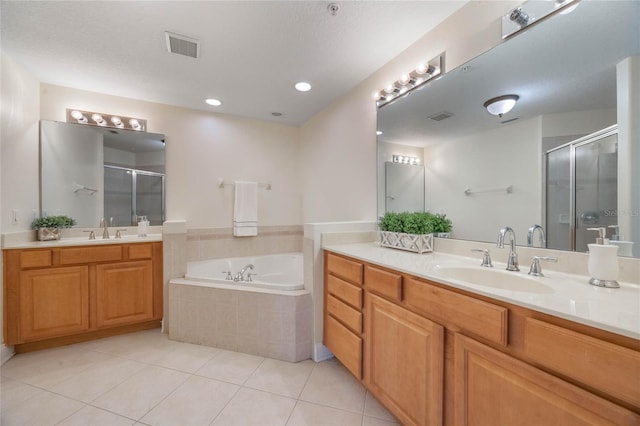 bathroom featuring tile patterned flooring, vanity, and separate shower and tub