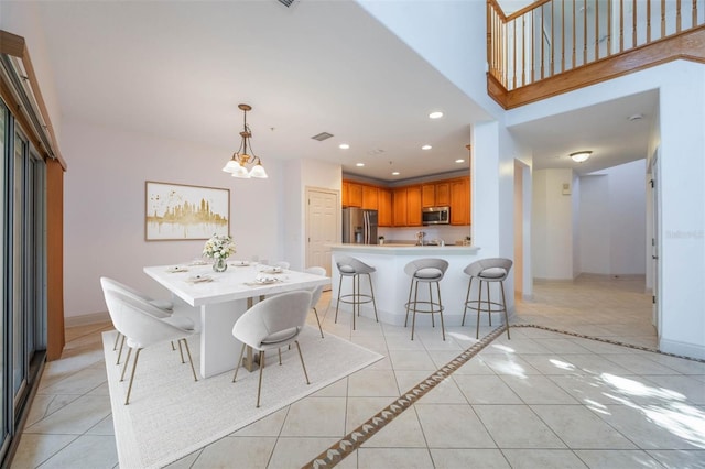 dining area featuring light tile patterned flooring and a chandelier