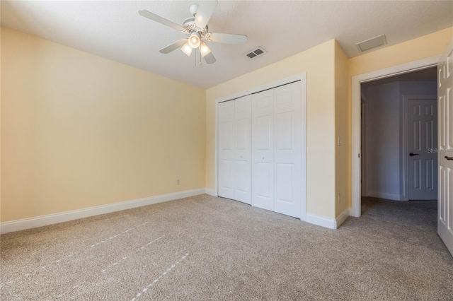 unfurnished bedroom with carpet flooring, ceiling fan, and a closet