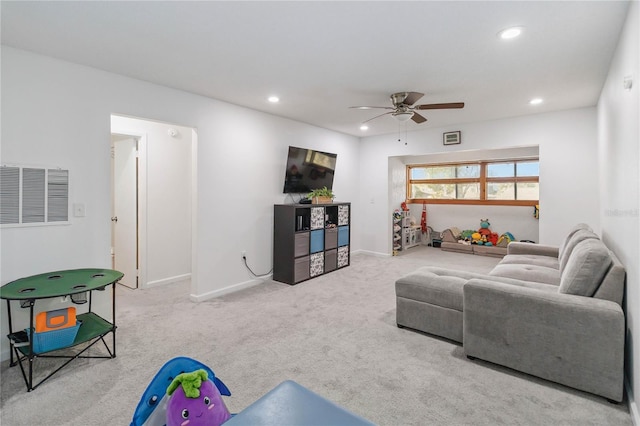 carpeted living room featuring ceiling fan