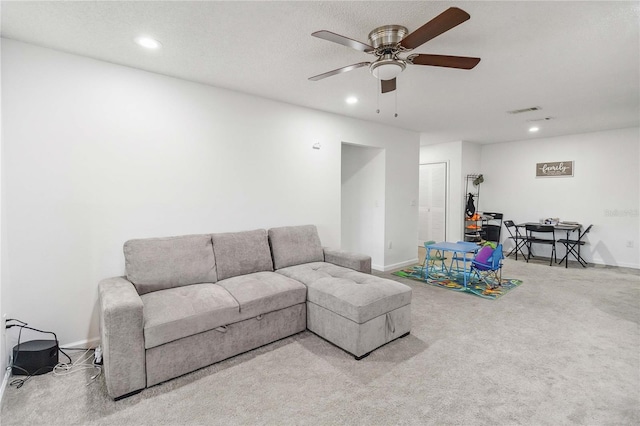 carpeted living room featuring ceiling fan