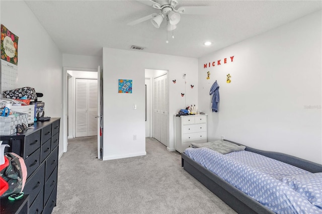 carpeted bedroom featuring ceiling fan and a closet