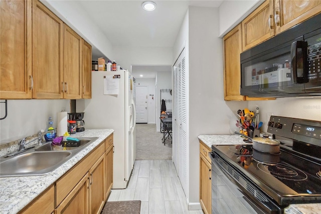 kitchen with light stone counters, sink, light carpet, and black appliances