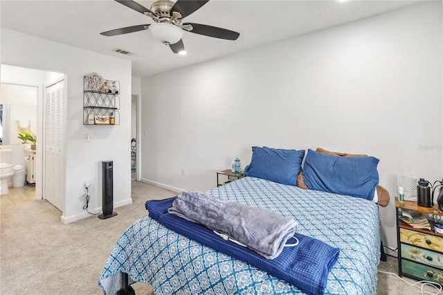 carpeted bedroom featuring connected bathroom, a closet, and ceiling fan