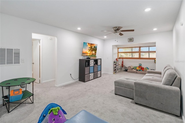 living room with light colored carpet and ceiling fan