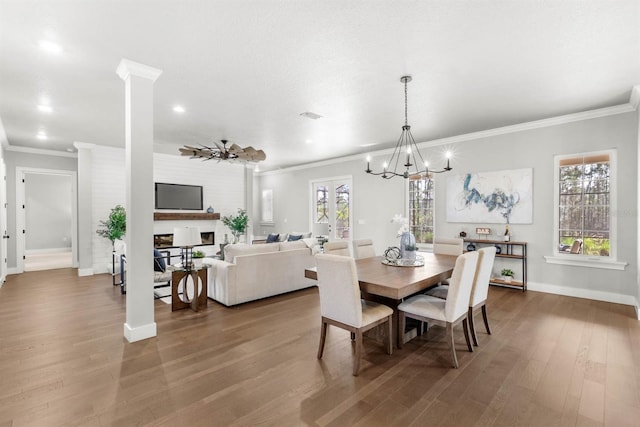 dining space with ornamental molding, hardwood / wood-style floors, and an inviting chandelier