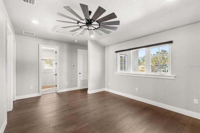 empty room featuring dark wood-type flooring and a textured ceiling