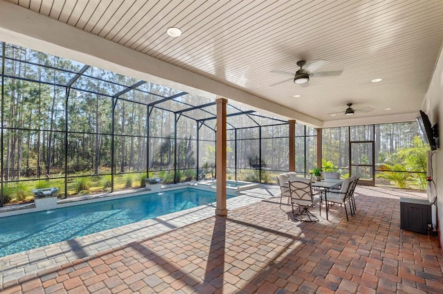 view of swimming pool featuring ceiling fan, glass enclosure, and a patio area