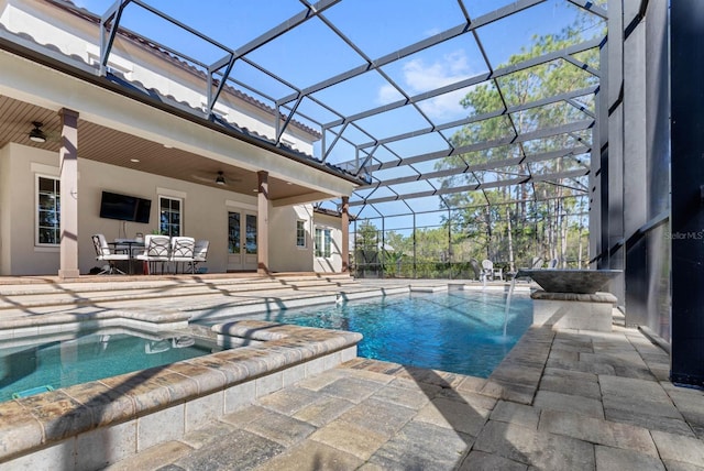 view of pool featuring an outdoor hangout area, a patio area, ceiling fan, and glass enclosure