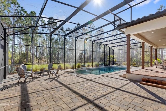 view of swimming pool with a lanai and a patio area